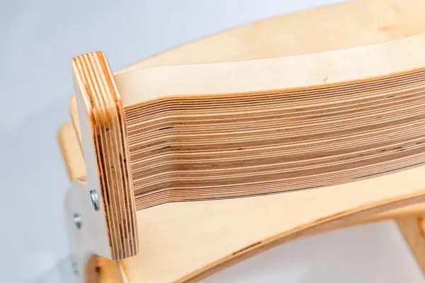 Close-up of the chair's edge showing the thin birch layers