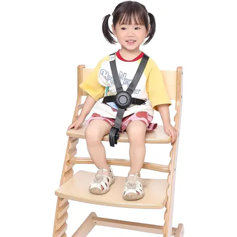 Toddler buckled into the Fornel chair with the black 5-point harness